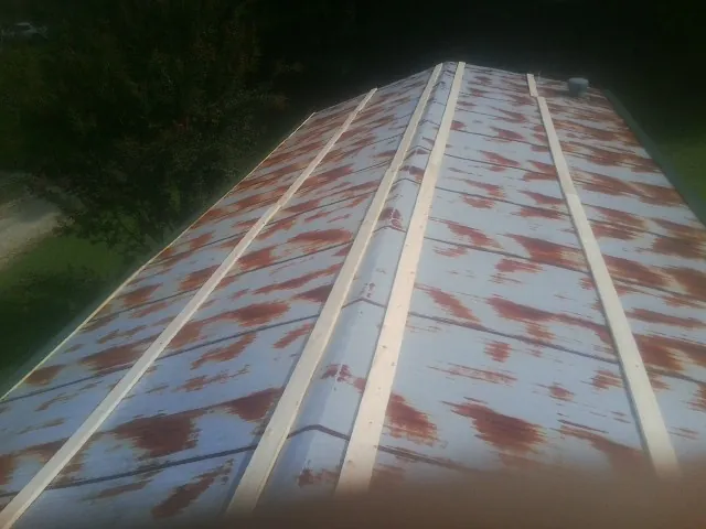 Rusted metal roof panels with new wood purlins before replacement — Storm Damage Roof Repair in Mount Hermon by Roofing Brothers