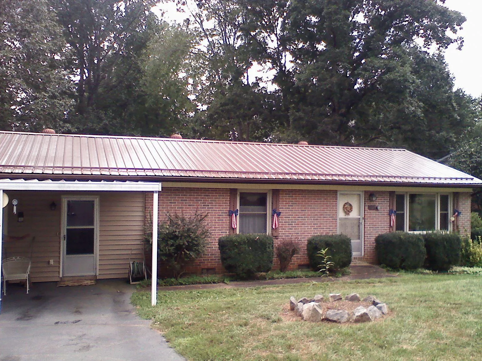 Bronze metal roof and carport on a brick ranch home — Roof Repair work by our crew in Mount Hermon