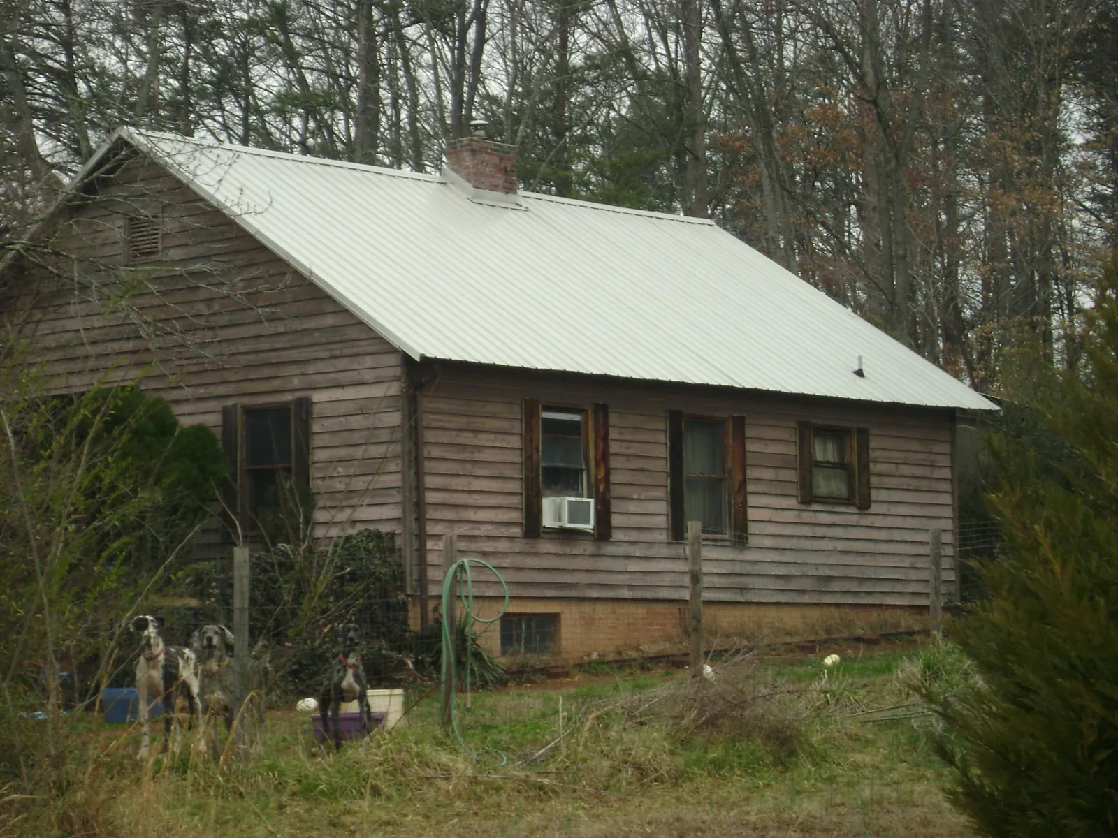 White metal roof on an old wood sided farmhouse, from a Metal Roof Installation job in Mount Hermon